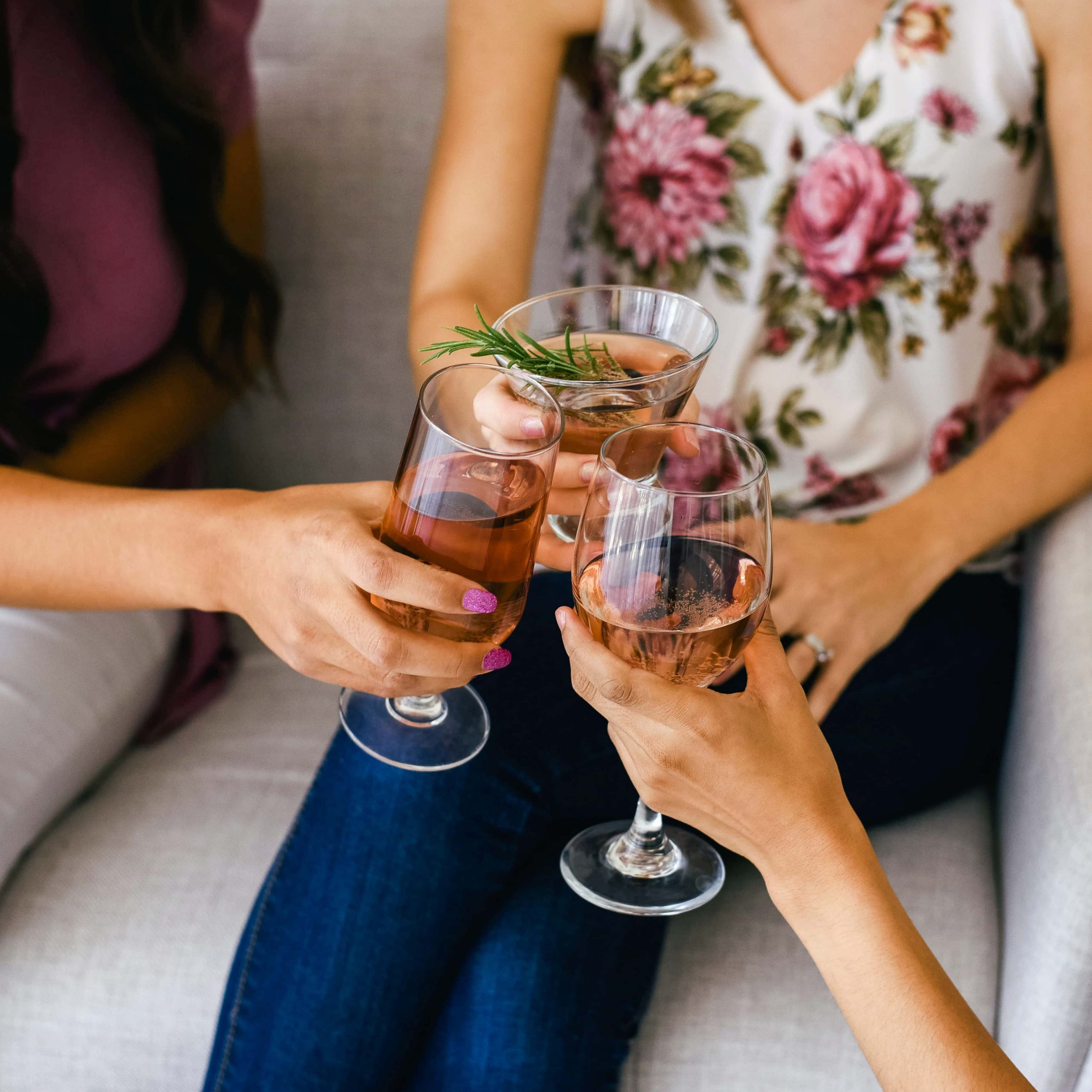 Women toasting each other with a drink