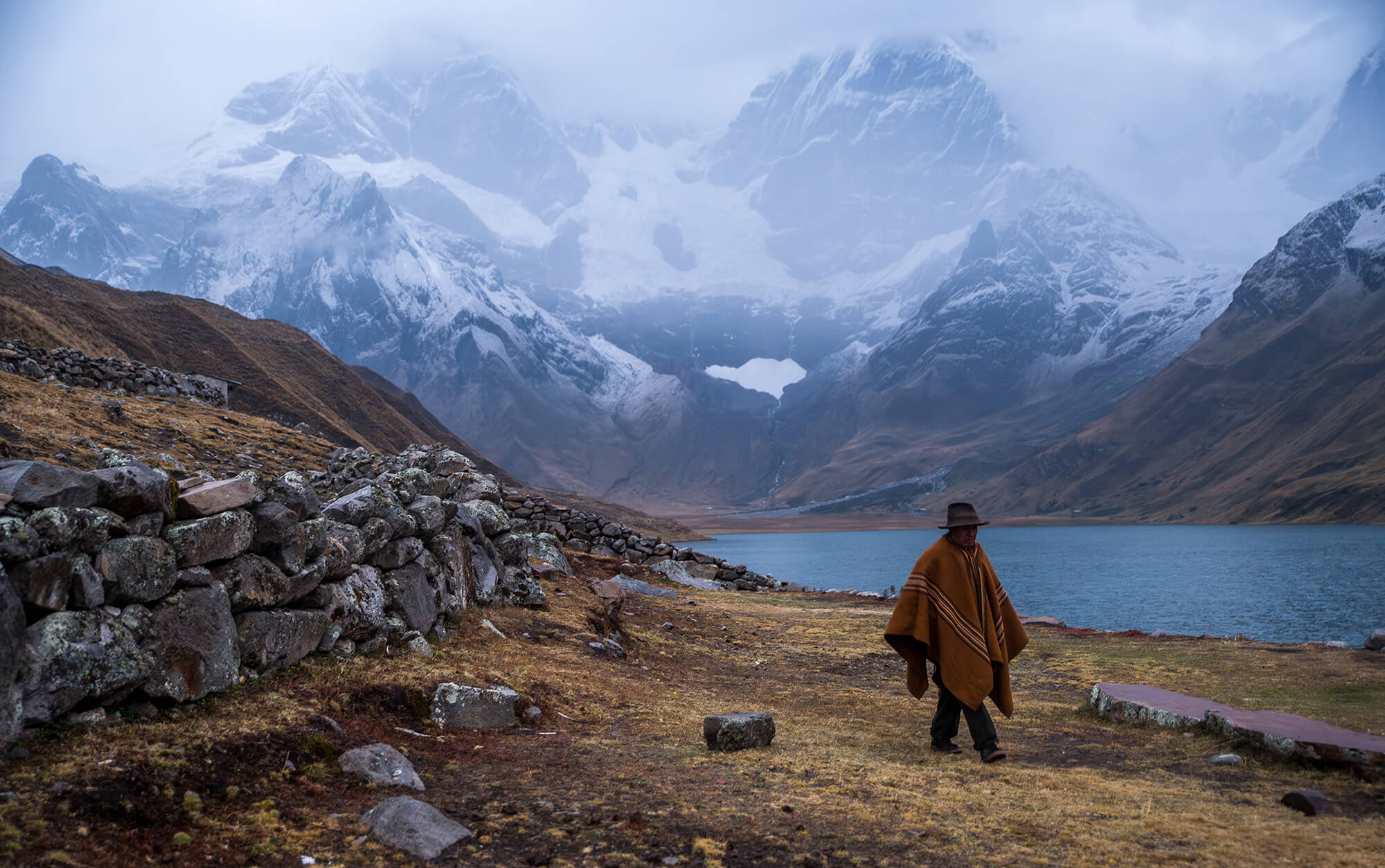 A mountainous region of Peru with a native man walking in the foreground