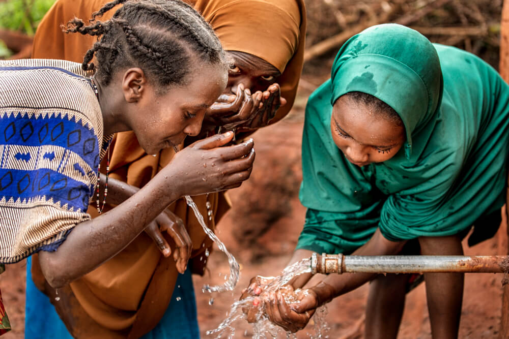 Women drink fresh water in Ethiopia