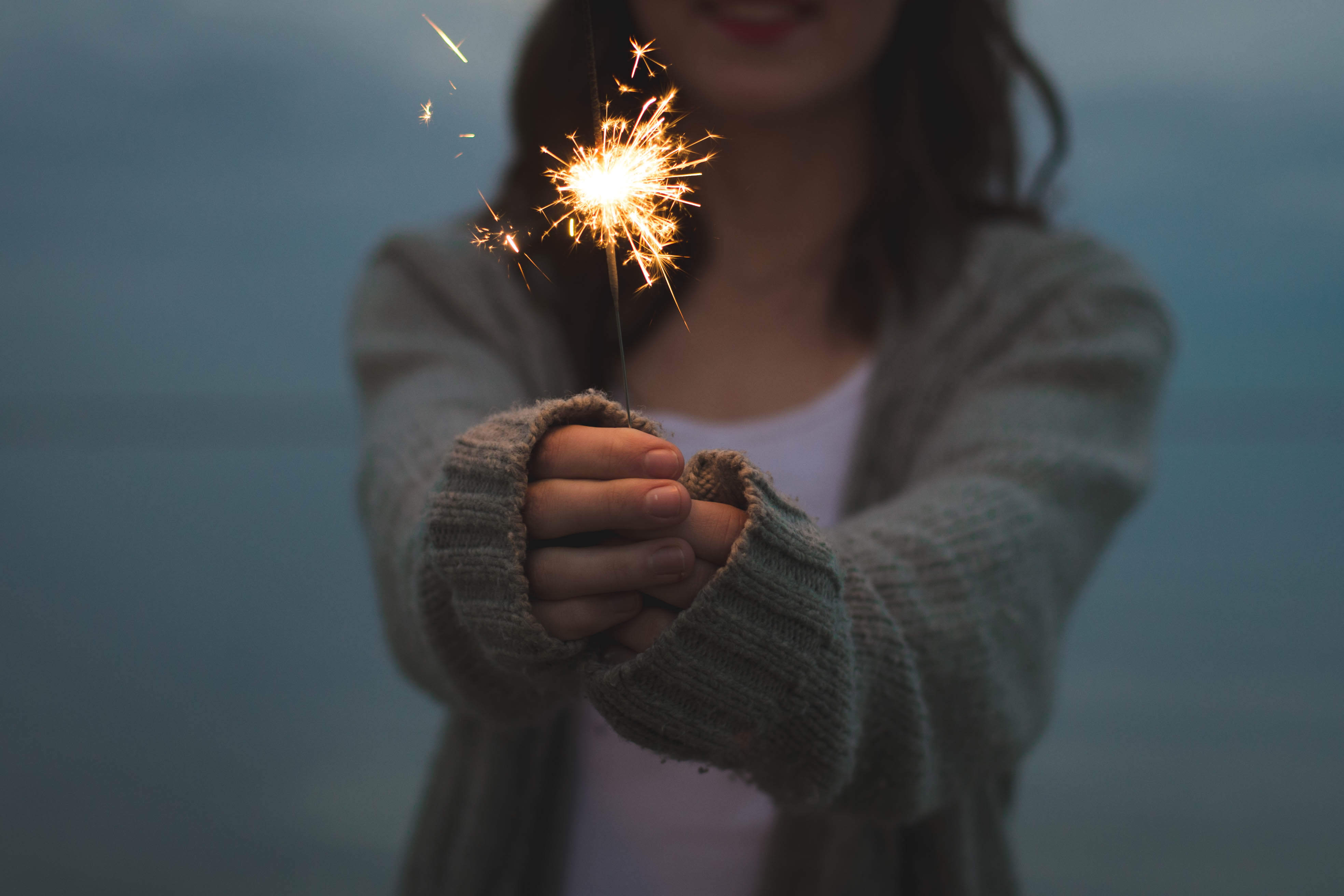 woman holding a lit sparkler