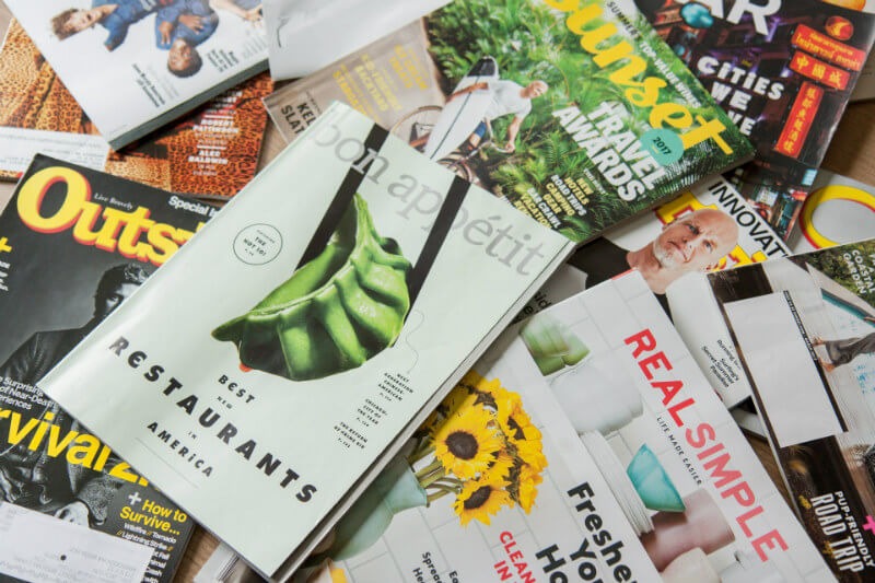 A pile of colourful printed magazines