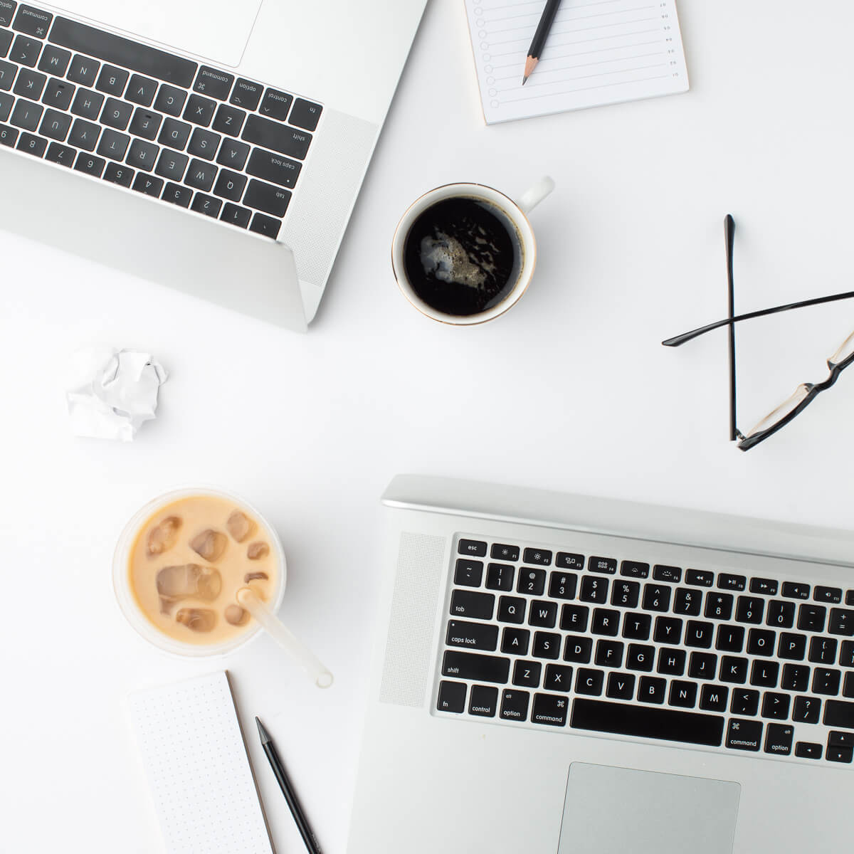 laptop and black coffee on a desk