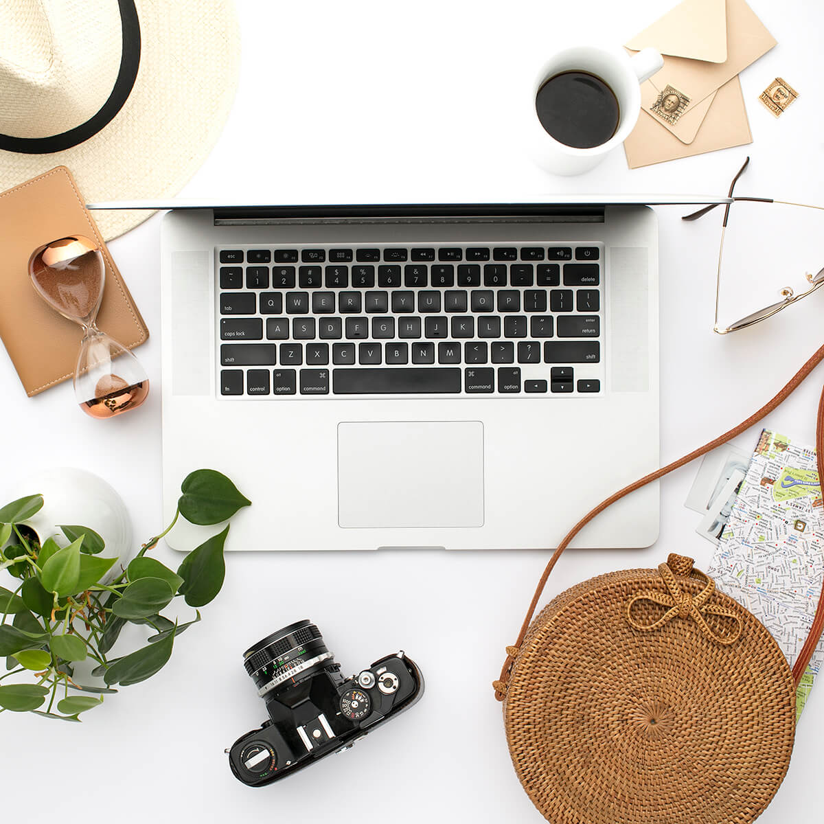 Camera on desktop with laptop hat and handbag