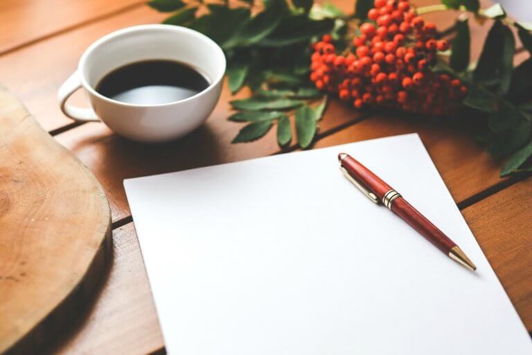 Blank page with pen and black coffee