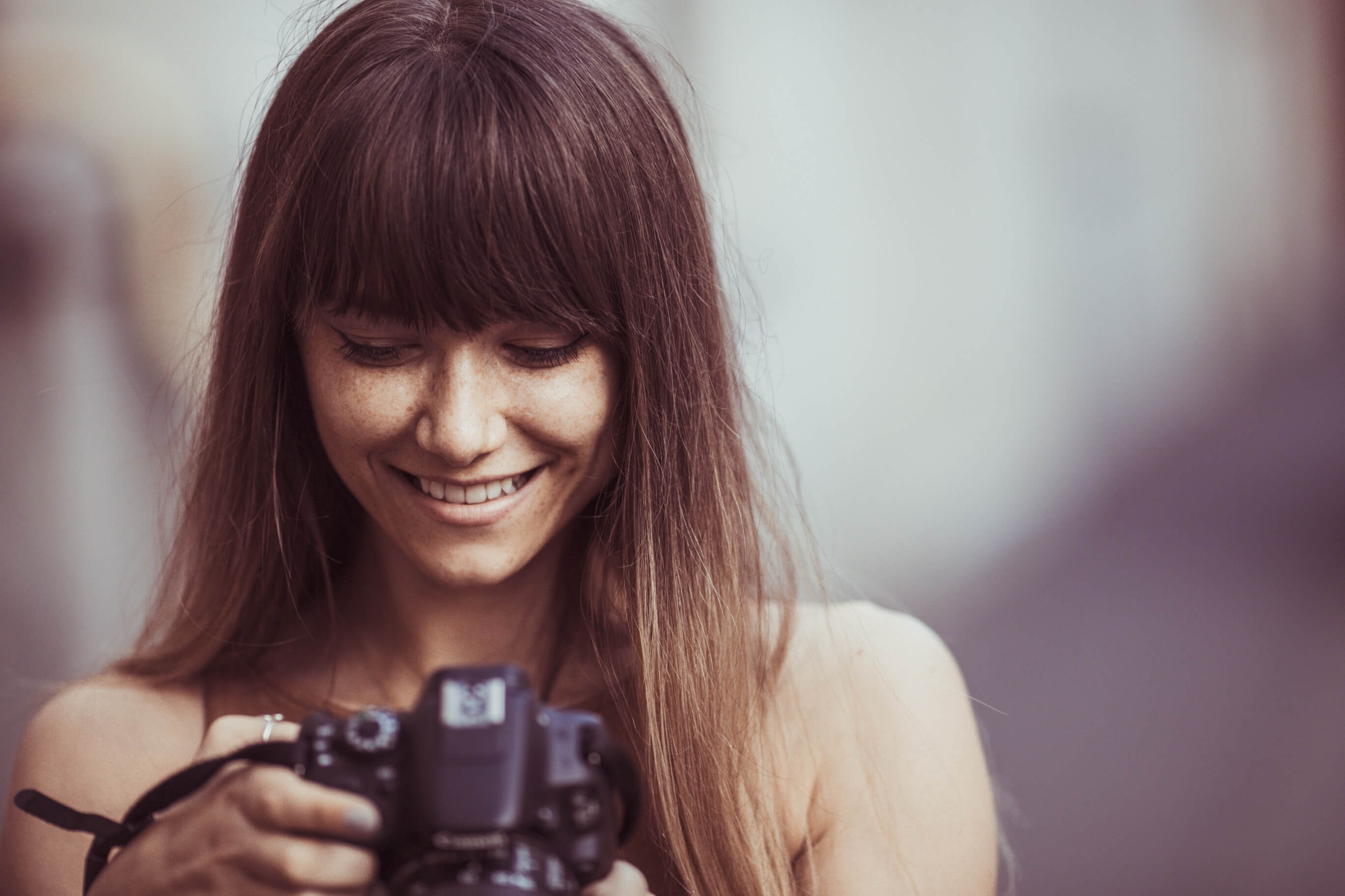 Female photographer looking at her camera