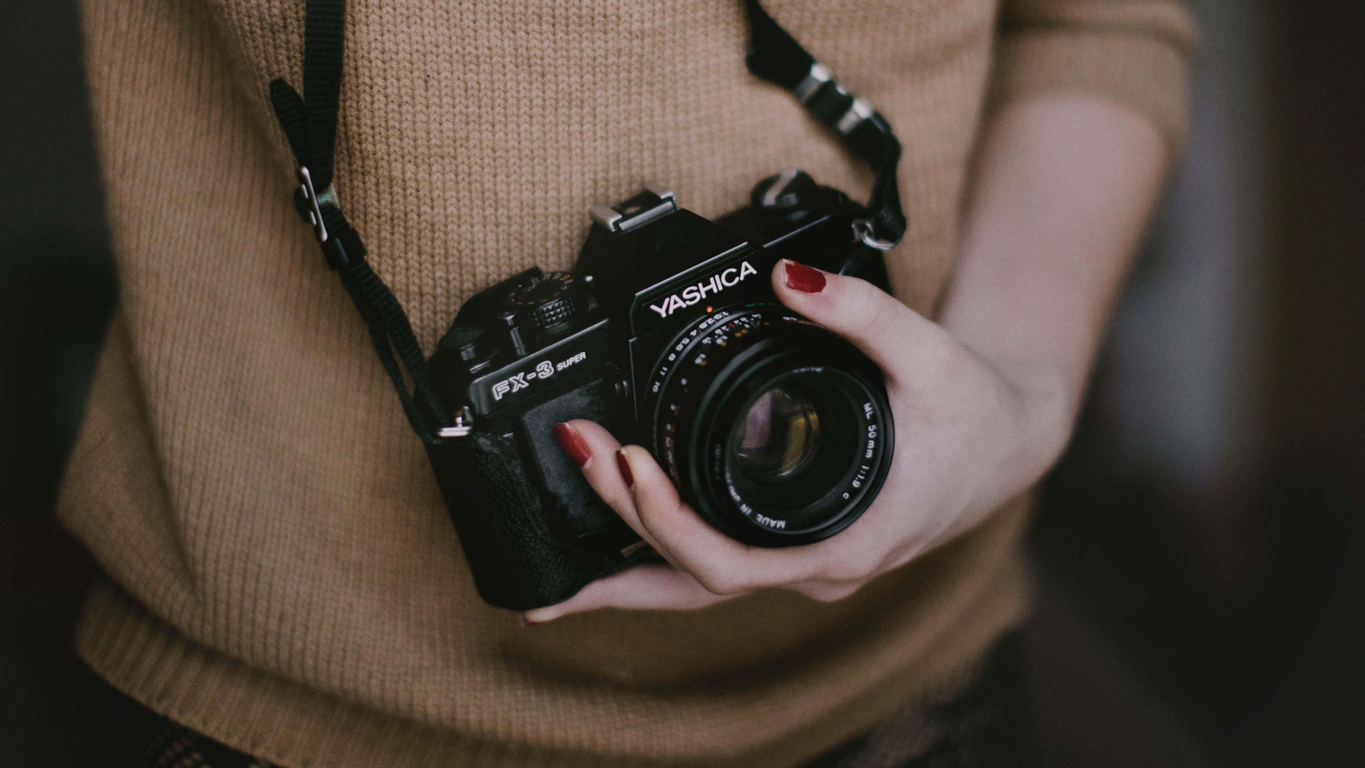Woman holding a camera in her left hand